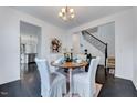 Cozy dining room featuring a wood table with covered chairs, hardwood floors, and stylish decor at 3338 Prospect Parkway Pkwy, Durham, NC 27703