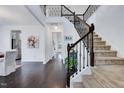 Bright entryway with beautiful hardwood floors, staircase with decorative wrought iron railing at 3338 Prospect Parkway Pkwy, Durham, NC 27703