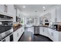 Modern kitchen featuring white cabinets, stainless steel appliances, granite countertops, and dark hardwood floors at 3338 Prospect Parkway Pkwy, Durham, NC 27703