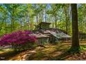 Unique home exterior featuring a beautiful sunroom and vibrant landscaping at 3719 W Cornwallis Rd, Durham, NC 27705