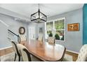 Bright dining room with a large window, stylish lighting, and comfortable seating for Gathering and guests at 416 Glenview Ln, Durham, NC 27703