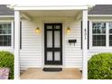 Close-up of the front door featuring the house number, black door, and decorative sconces at 431 Waddill St, Henderson, NC 27536