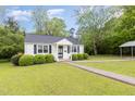 Charming one-story home with a well-kept lawn and walkway, perfect for a cozy and inviting entrance at 431 Waddill St, Henderson, NC 27536