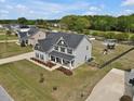 Lovely two-story home with a well-maintained lawn, mature trees, and backyard play area at 46 Twelve Oaks Dr, Willow Springs, NC 27592