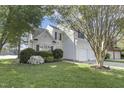Two-story home with a manicured lawn, flowering shrubs, and attached two-car garage at 512 N Waters Edge Dr, Durham, NC 27703