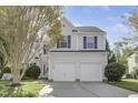 Charming two-story home with a two-car garage, manicured lawn, and mature trees at 512 N Waters Edge Dr, Durham, NC 27703