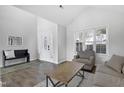 Bright living room featuring wood floors, neutral decor, vaulted ceilings, and ample natural light at 512 N Waters Edge Dr, Durham, NC 27703