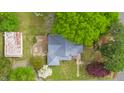 Bird's-eye view of a house with a metal roof, set in a lush, green landscape at 516 W Fourth St, Siler City, NC 27344