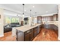 Gourmet kitchen with granite island, stainless steel appliances, and custom cabinets, perfect for culinary enthusiasts at 521 Wildwood Farm Way, Holly Springs, NC 27540
