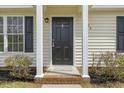 Inviting front entrance featuring a classic door and well-maintained landscaping at 5505 Armada Dr, Raleigh, NC 27610