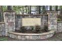 Stone sign for Walker Woods community, framed by lush greenery and shrubbery at 572 W Walker Woods Ln, Clayton, NC 27527
