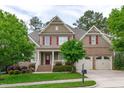 Charming home featuring red shutters, well-manicured lawn, and a two-car garage, set in a beautiful neighborhood at 629 Peach Orchard Pl, Cary, NC 27519