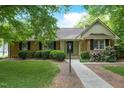 Charming brick home with manicured bushes and mature landscaping at 704 W Front St, Burlington, NC 27215