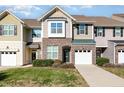 Inviting townhome featuring a one-car garage and well maintained landscaping at 7328 Caversham Way, Raleigh, NC 27617