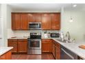 Well-equipped kitchen featuring stainless steel appliances and granite countertops at 7328 Caversham Way, Raleigh, NC 27617