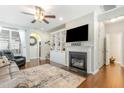 Inviting living room featuring fireplace, built-ins, and ceiling fan at 7328 Caversham Way, Raleigh, NC 27617