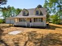 Quaint home featuring a white picket fence, dormer windows and detached garage at 7702 Nc Highway 581, Kenly, NC 27542