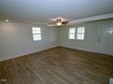 A large open living room with ample light, featuring luxury vinyl plank flooring at 7702 Nc Highway 581, Kenly, NC 27542