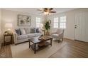 Bright living room featuring a comfortable sofa, accent chair, and neutral decor at 7702 Nc Highway 581, Kenly, NC 27542