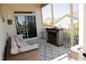 Relaxing screened-in porch with comfortable seating and a cozy fireplace, perfect for year-round enjoyment at 828 Traditions Ridge Dr, Wake Forest, NC 27587