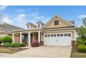 Charming home featuring a two-car garage, dormer windows, manicured landscaping, and beautiful curb appeal at 833 Gaston Manor Dr, Durham, NC 27703