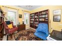 Comfortable living room with large bookshelf, accent rug, and two chairs at 833 Gaston Manor Dr, Durham, NC 27703