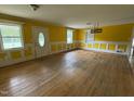 Bright living room featuring hardwood floors, trim, and a large window at 8535 Us-301 S Hwy, Four Oaks, NC 27524