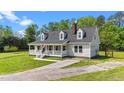 Charming home featuring a welcoming front porch, dormer windows, and a well-maintained front yard at 8700 Crowder Rd, Raleigh, NC 27603