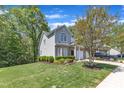 Beautiful home with lush greenery, mature trees, a well-kept lawn, and a private driveway at 9005 River Estates Dr, Knightdale, NC 27545