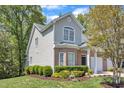 Charming brick home with two-car garage, lush green lawn, and attractive landscaping at 9005 River Estates Dr, Knightdale, NC 27545