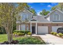 Charming brick home featuring a well-manicured lawn, two-car garage, and inviting front porch at 9005 River Estates Dr, Knightdale, NC 27545