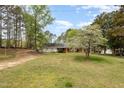 Charming home with brick accents and a serene front yard with mature trees providing ample shade at 903 Creech Rd, Garner, NC 27529