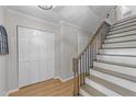 Inviting foyer featuring a staircase, closet, and wood flooring with neutral paint at 1020 Randolph Ct, Cary, NC 27511