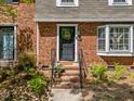 Close-up of the townhouse's front door, showcasing the brick facade and landscaping at 1020 Randolph Ct, Cary, NC 27511