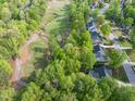 An aerial view of the property, highlighting its proximity to a scenic golf course and lush landscaping at 105 Hein Dr, Clayton, NC 27527