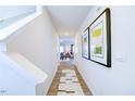 Inviting hallway with wood floors, stylish decor, and a view of the open-concept living area at 108 Red Maple St, Sanford, NC 27332