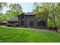 Charming two-story home with a modern brick exterior, large windows, and well-manicured lawn at 10805 The Olde Pl, Raleigh, NC 27614