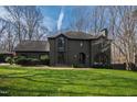 Attractive two-story home with a well-kept lawn, complemented by the surrounding mature trees at 10805 The Olde Pl, Raleigh, NC 27614