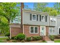 Charming brick and siding townhouse with a manicured lawn and inviting front entrance at 120 Barbary Ct, Cary, NC 27511