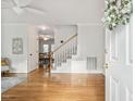 Bright foyer features gleaming hardwood floors, staircase, and a view into the dining room at 120 Barbary Ct, Cary, NC 27511