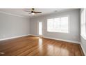 Open bedroom with hardwood floors and a ceiling fan at 126 W Savannah Ridge Rd, Holly Springs, NC 27540
