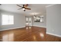 Inviting living room showcasing hardwood floors, natural light and an open layout to the kitchen at 126 W Savannah Ridge Rd, Holly Springs, NC 27540