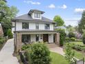 Inviting two-story home with well-manicured front yard, pathway, and a quaint front porch at 1306 Mordecai Dr, Raleigh, NC 27604
