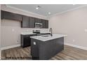 Modern kitchen features black cabinets, stainless steel appliances, and a convenient island at 133 Pearl St # 7, Garner, NC 27529