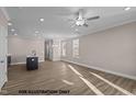 Open-concept living area with recessed lighting, plank flooring, and bright windows at 133 Pearl St # 7, Garner, NC 27529