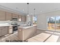 Modern kitchen boasts an island, stainless steel appliances, and a sliding glass door to a deck at 141 Pearl St # 9, Garner, NC 27529