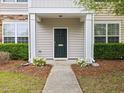 Close-up of a well-maintained front exterior with a blue door and manicured landscaping at 1605 Grace Point Rd, Morrisville, NC 27560