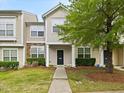 Charming townhome with manicured lawn, walkway, neutral siding, and stone accents at 1605 Grace Point Rd, Morrisville, NC 27560
