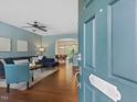 View from front door into living room with hardwood floors and furniture at 1605 Grace Point Rd, Morrisville, NC 27560