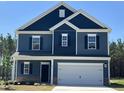 Inviting two-story home boasts blue siding, white trim, and a convenient two-car garage at 172 Knoll Way, Sanford, NC 27332